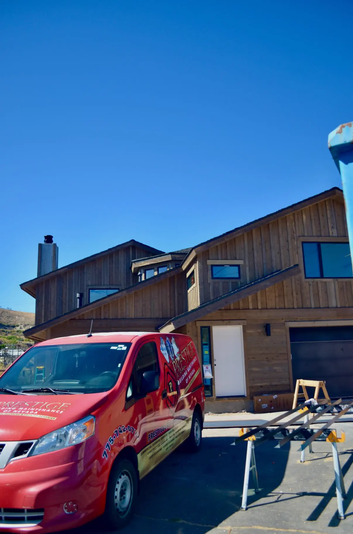 Prestige of Nevada service van parked at a commercial job site